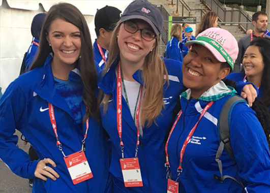 Three female LEND trainees at the Chicago Marathon. One is holding a prosthetic leg.