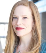 Fair-skinned woman in her early forties with strawberry blonde hair and green eyes.