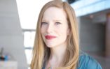 Fair-skinned woman in her early forties with strawberry blonde hair and green eyes.