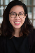 Litany Esguerra, an Asian American woman smiling and wearing glasses