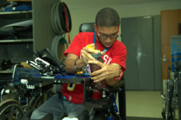 Garett Jones test a newly-adapted cup holder installed on his wheel chair 