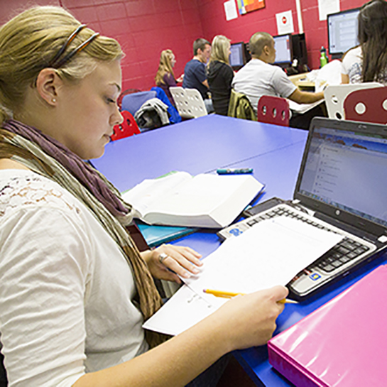 Girl in ASAP studying at her laptop