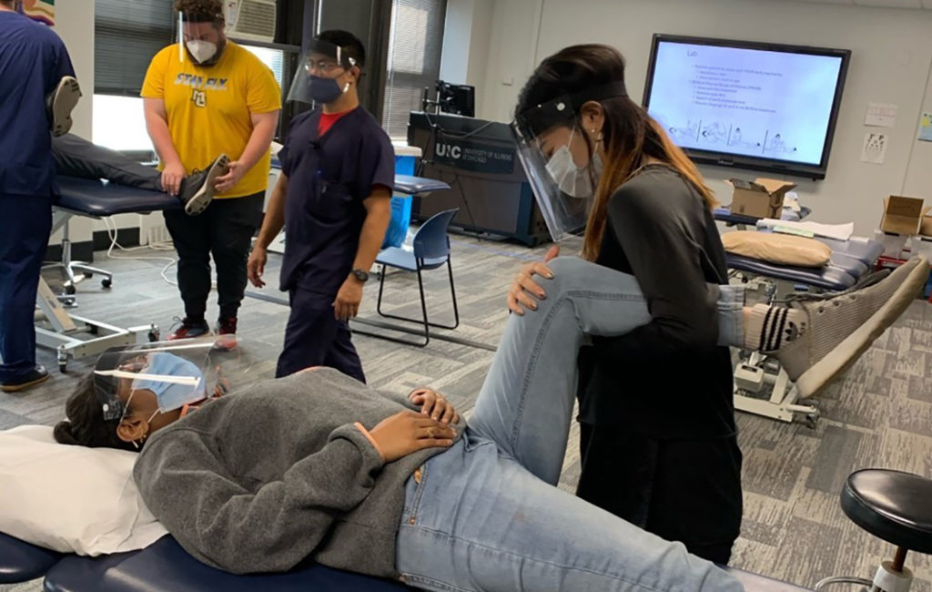 First-year DPT students participate in a bed mobility and body mechanics lab