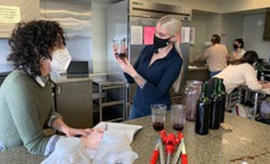 Nutrition students are performing a sensory evaluation of the wine they just produced from the previous class; on the side, are two jars of tea with SCOBY to make kombucha. 