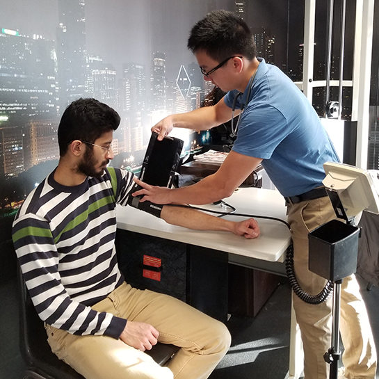 taking blood pressure of a seated man